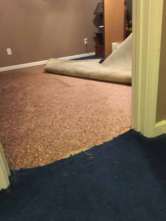 Carpet pad removal revealing water damage during Water Mitigation Services in Summit